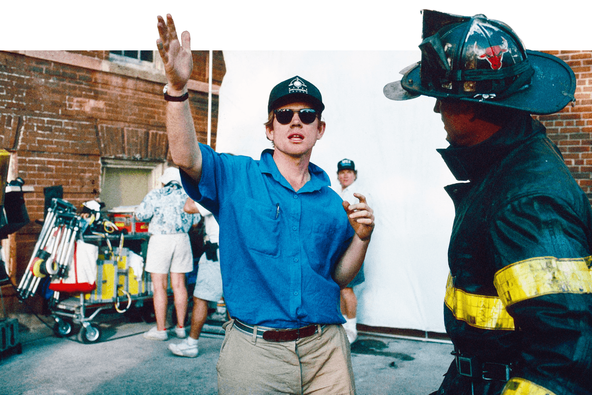 Ron Howard directing on a Chicago street beside a firefighter.